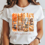Бяла дамска тениска с акварелен принт, разделен на четири вертикални панела с горски животни в есенен пейзаж: лисица, елен, бяла сова и катерица. Надпис: "Fall is my favorite color".