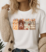 Дамска тениска с есенна визия, четири висящи табелки с буквите F A L L и различни есенни мотиви